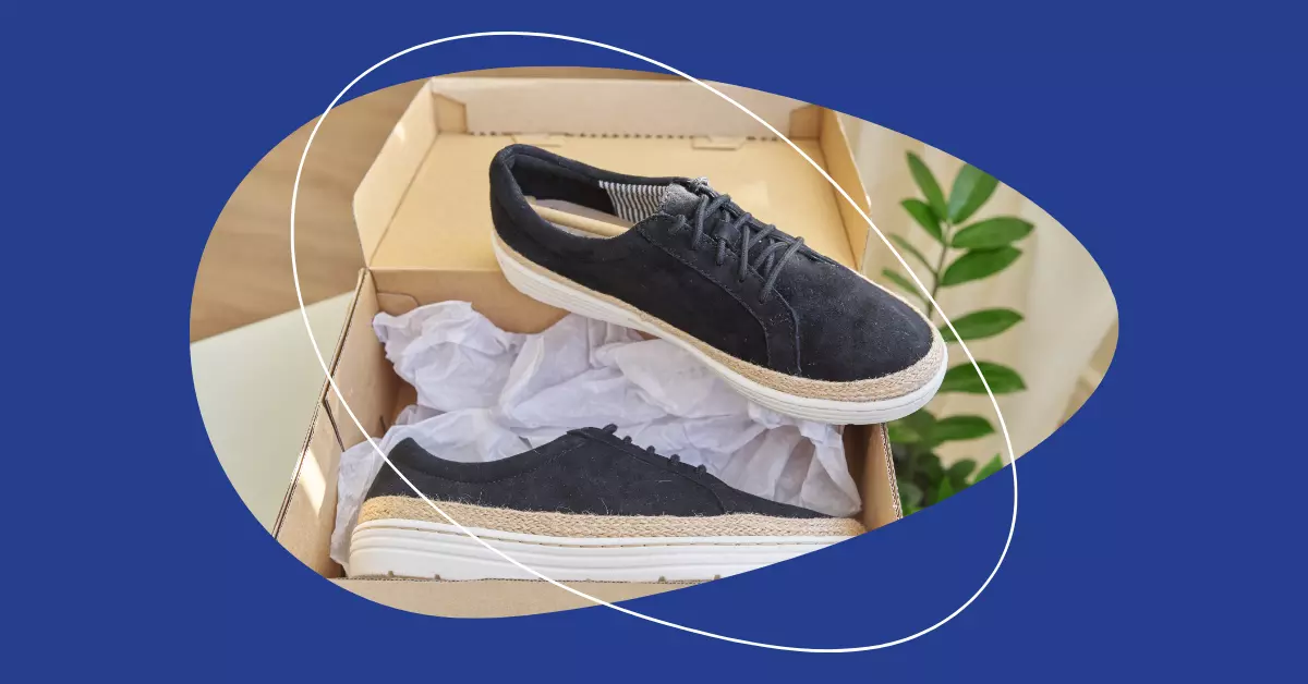 A pair of black sneakers in a box